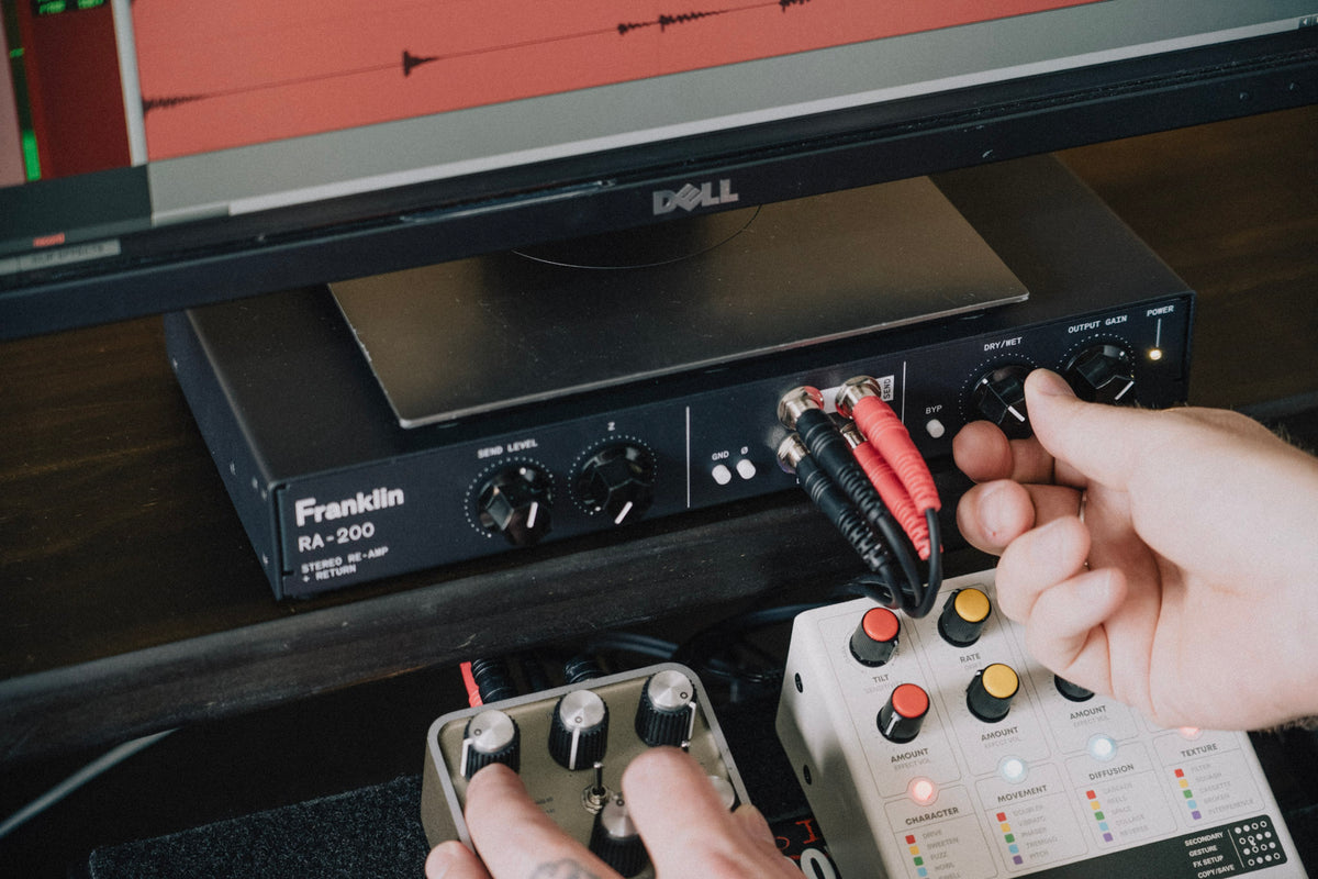 Patching a pedal into the RA-200 front-panel jacks on a desktop setup