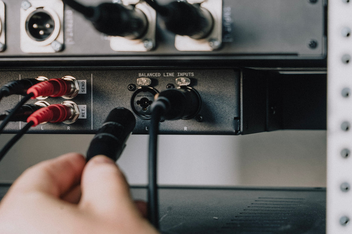 Balanced cables being plugged into the RA-200 rear line inputs